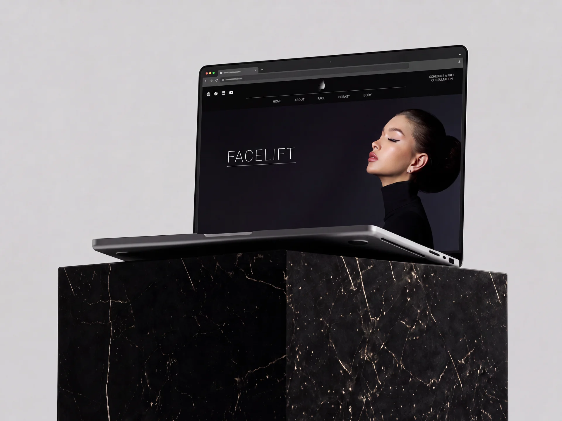 Nassar Plastic Surgery website on laptop displayed on a black marble podium
